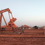 An oil well in Midland, Texas, idled by the world oil glut is juxtaposed against partially built homes caught in the oil bust. (Photo by Spencer Platt/Getty Images)