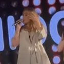 Adele takes the stage with a topless dancer at a London Gay club last night (Feb. 10). (Photo: YouTube/ScreenCap)