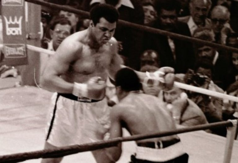 Muhammad Ali squares off against Jimmy Young in 1976. Ali's memorabilia is expected to draw high rollers when it goes up for auction Sept. 10. (Photo by Keith Girard)