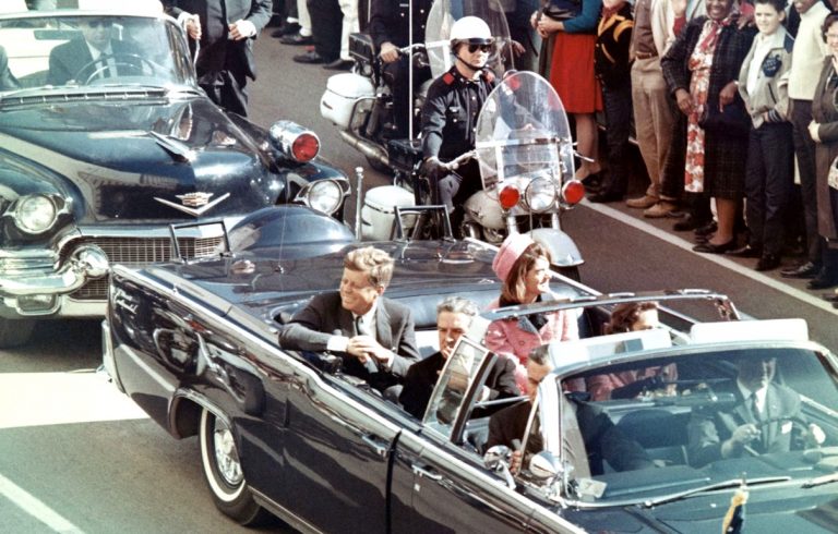 President Kennedy, his wife, Jacqueline and then-Texas Gov. John Connley ride in an open car during their Dallas motorcade on Nov. 22, 1963.