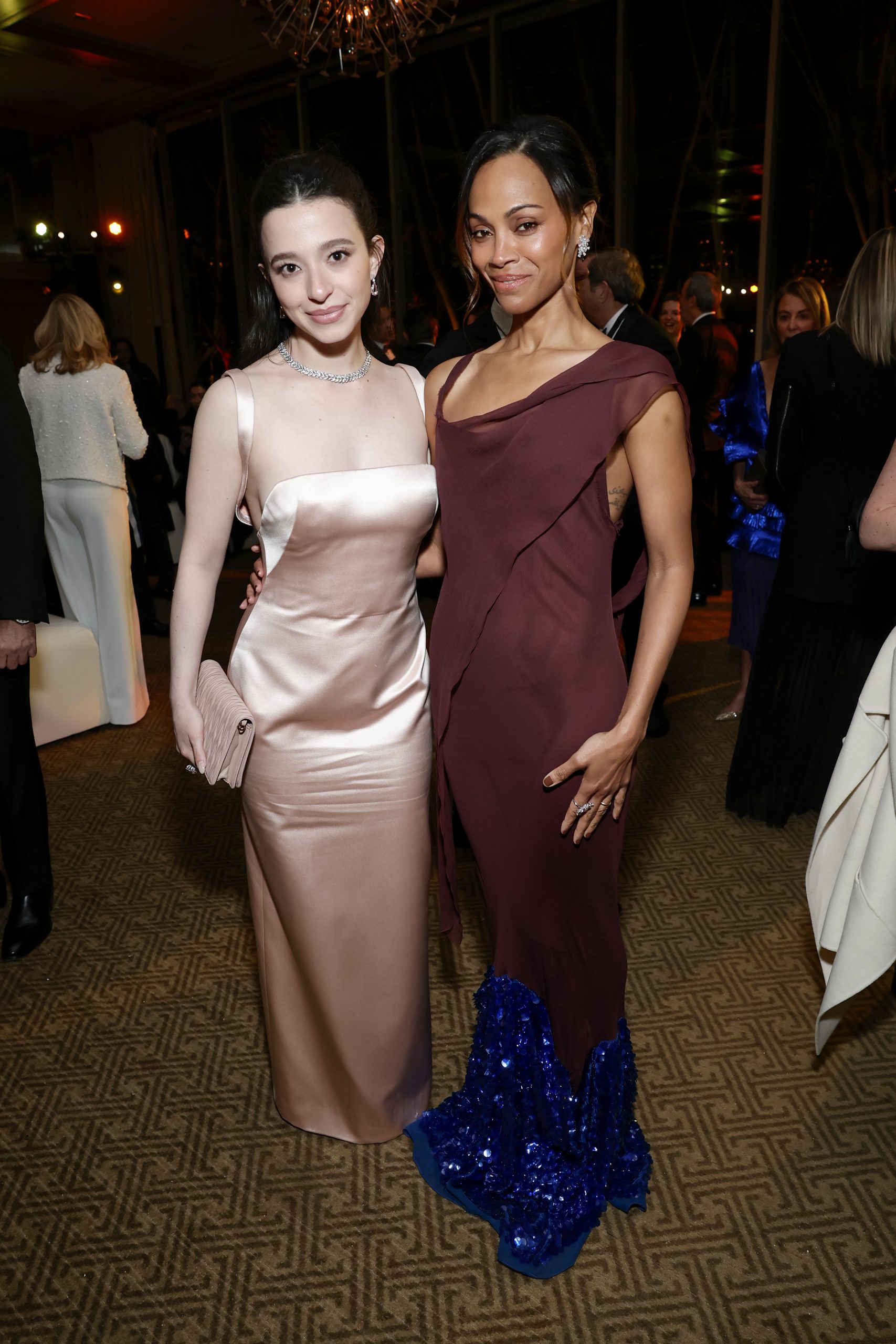 Mikey Madison and Zoe Saldana bond at the After Party for the 36th Annual Palm Springs International Film Awards. (Photo by Emma McIntyre/Getty Images for Palm Springs International Film Society)