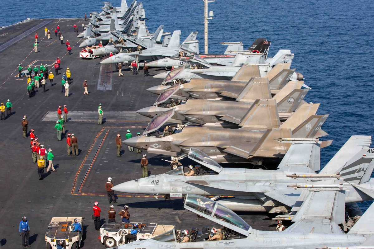 Aircraft attached to Carrier Air Wing (CVW) 9 sit on the flight deck of Nimitz-class aircraft carrier USS Abraham Lincoln (CVN 72) in support of Operation Epic Fury, Feb. 28, 2026. (U.S. Navy photo)
