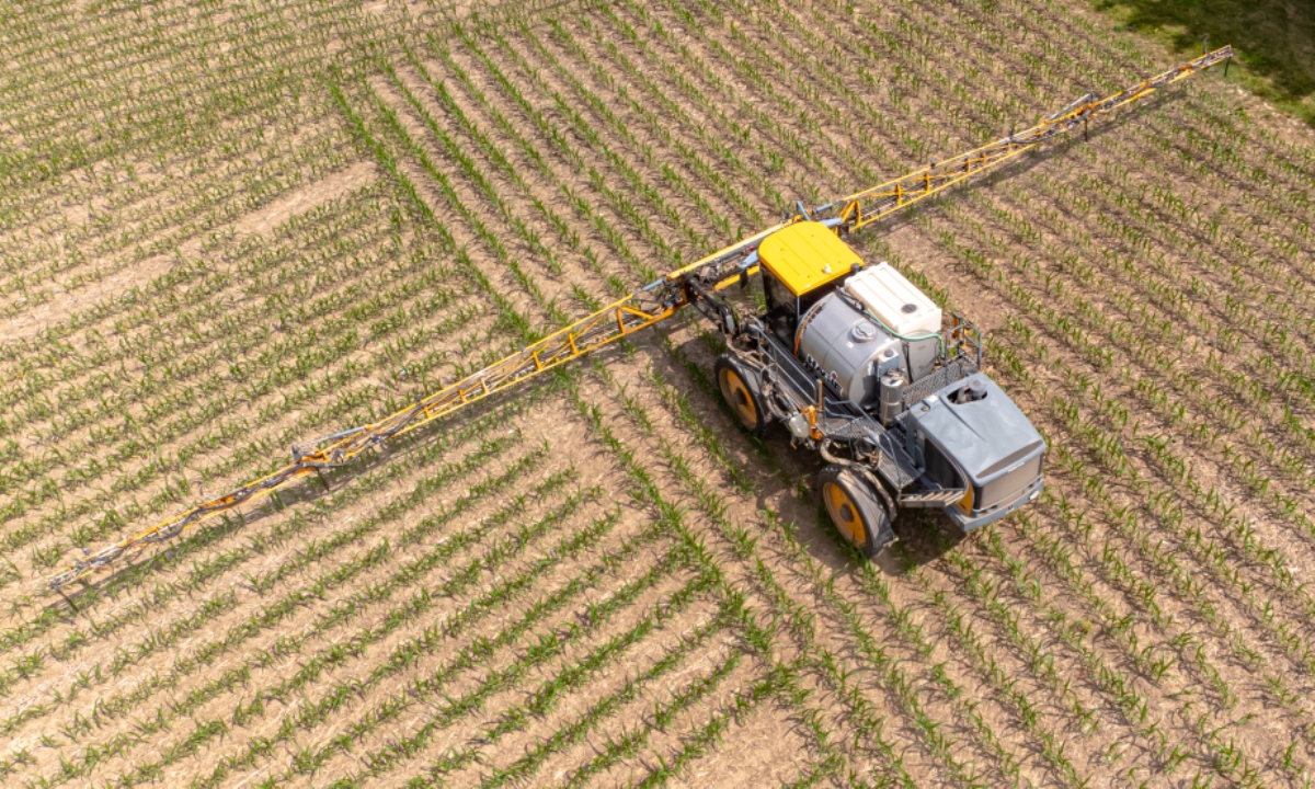 A farmer spreads liquid fertilizer on crops during planting season. (Photo